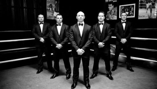 Group of grooms men looking dressed in tuxedos